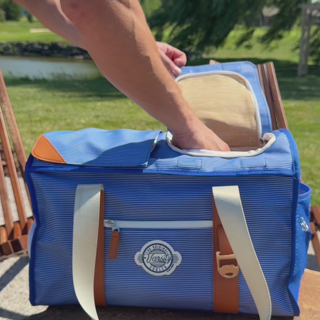 Golfer reaches from the cart seat, opens the magnetic flap and removes a cold drink from the Course Cruiser.